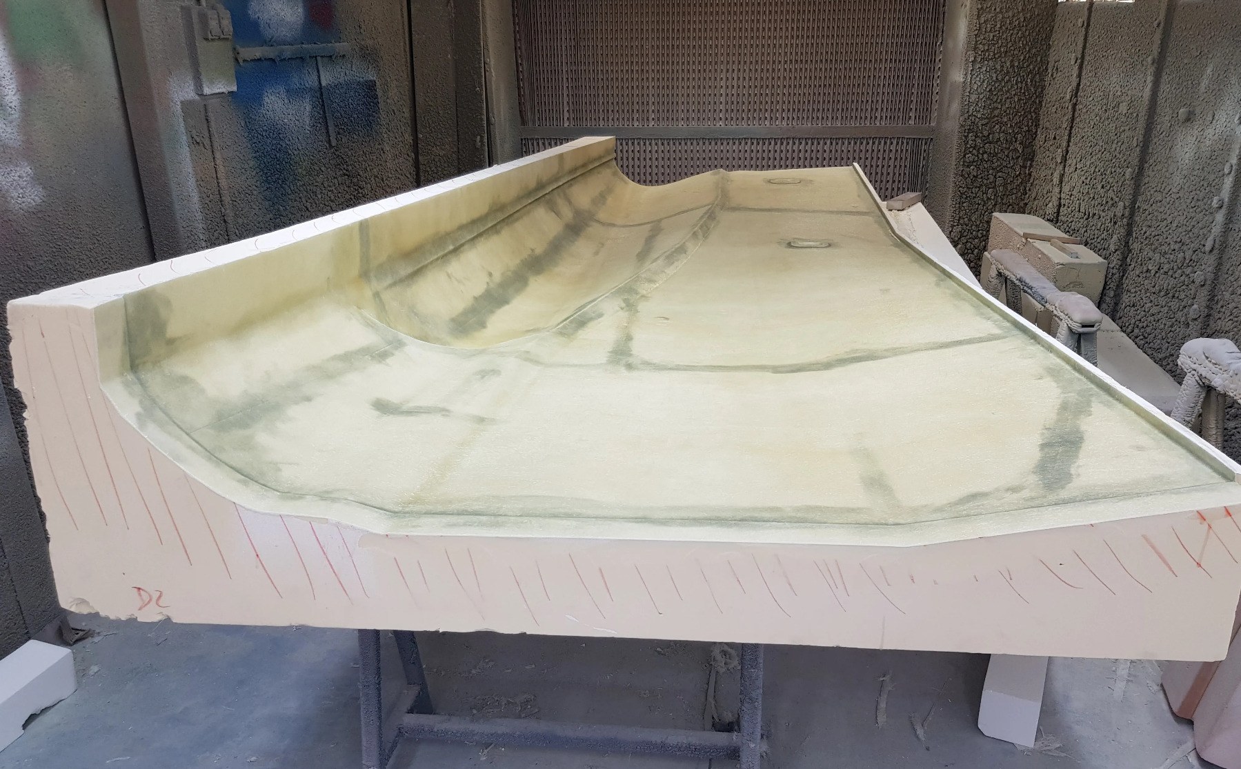 Sub-photo — Stratification en fibre de verre et résine dans le moule usiné en mousse polyuréthane. C’est cette peau, une fois durcie, qui donne la carrosserie de la maquette.